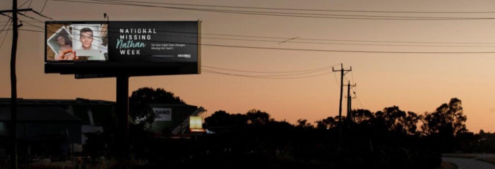 Missing persons billboard at night